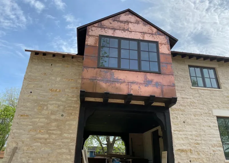 Copper metal panel facade on a stone building for Skylight Installation in South Jordan